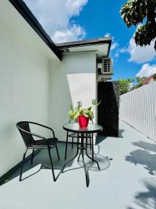 a patio with a table and two chairs on it at Our Lovely Nest, Free Parking & Wi-Fi in Miami