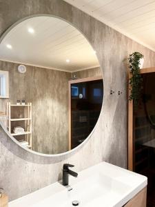 a bathroom with a sink and a mirror at Lofotlove Apartments - Modern and Comfy Apartments Close To Nature in Sørvågen