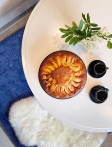 a cake on a white plate on a table at Modern & Cozy Apartments Close To Nature, West Lofoten in Sørvågen