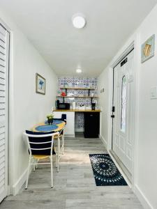 a dining room with a table and chairs and a kitchen at Our Lovely Nest, Free Parking & Wi-Fi in Miami