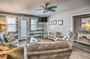 a living room with two couches and a ceiling fan at Waterfront Ocean Isle Beach Condo with Balcony! in Ocean Isle Beach