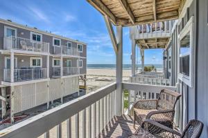 a view of the beach from the balcony of a beach house at Waterfront Ocean Isle Beach Condo with Balcony! in Ocean Isle Beach