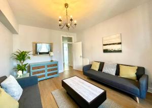 a living room with a couch and a table at South Bridge Apartment in Edinburgh