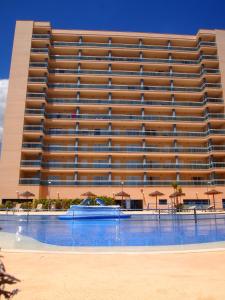 a large building with a swimming pool in front of it at Apartamentos Europa House Sun Beach in Guardamar del Segura