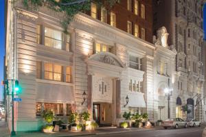 a large white building on a city street at night at International House Hotel in New Orleans