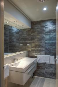 ein Bad mit einem Waschbecken und einem Spiegel in der Unterkunft Brougham Arms Hotel in Bendigo