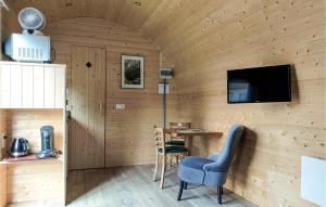 a room with a table and chairs and a television at Gorgeous Home In Haller With Kitchen in Haller