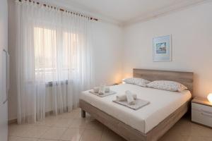 una camera da letto con un letto e due asciugamani di Marina a Rabac