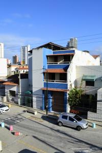 a car parked in a parking lot in front of a building at Iracema Praia Flats in Fortaleza