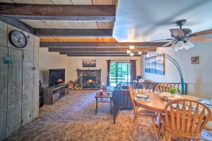 a dining room and living room with a table and chairs at San Bernardino Mtn Retreat with Furnished Deck in Running Springs