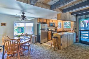a kitchen with a table and chairs and a refrigerator at San Bernardino Mtn Retreat with Furnished Deck in Running Springs