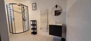 a bathroom with a shower and a sink and a mirror at Apartamenty Morski Brzeg - Sauna, Balia in Władysławowo +20 photos