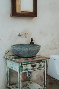 a bathroom with a bowl sink on a table at IMIX Hotel in Valladolid