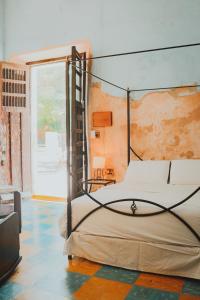 a bedroom with a bed with a metal frame at IMIX Hotel in Valladolid