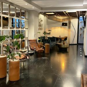 a lobby with potted plants and a living room at Condesa Cibel in Mexico City
