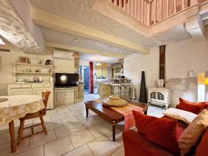 a living room with a couch and a table at Gîtes Elusate in Eauze