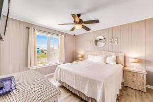 a bedroom with a bed and a ceiling fan at Sand Trap by Meyer Vacation Rentals in Gulf Shores