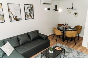 a living room with a couch and a table at Apartman Star #1 in Vinkovci