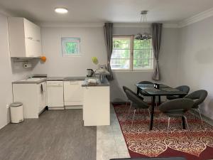 a kitchen with a table and chairs in a room at Stefánia Apartmanok Budapest in Budapest