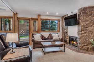 a living room with a couch and a fireplace at Laurelwood Condominiums 102 in Snowmass Village