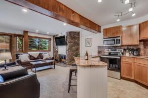 a kitchen and living room with a couch and a table at Laurelwood Condominiums 102 in Snowmass Village