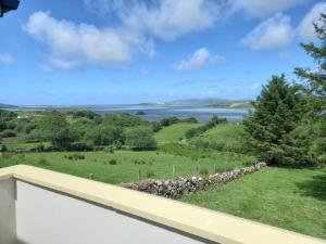 a view of the water from the balcony of a house at Jack's House in Glenties