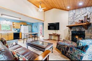 a living room with a couch and a fireplace at River's Edge in Cullowhee