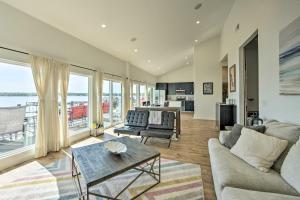 a living room with a couch and a table at Modern Cedar Creek Lake Retreat with Panoramic View! in Malakoff