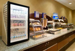 a bakery counter with a display of pastries at Holiday Inn Express Pittsburgh West - Greentree, an IHG Hotel in Pittsburgh