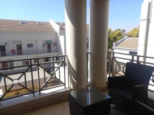 einen Balkon mit Stühlen und Blick auf ein Gebäude in der Unterkunft Mount Royal 31 - Large 1 bed with balcony in Johannesburg