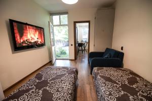 a bedroom with a bed and a fireplace and a couch at Centre Premium in Pärnu