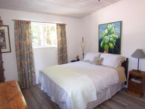 a bedroom with a large bed and a window at Malaspina Strait Cottage in Powell River