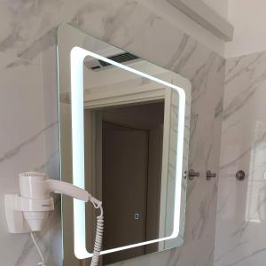 a mirror in a bathroom with a hair dryer at Apartment Park in Rabac +31 photos