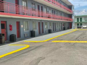 an empty street with yellow lines in front of a building at Budgetel Inn and Suites - Louisville in Louisville