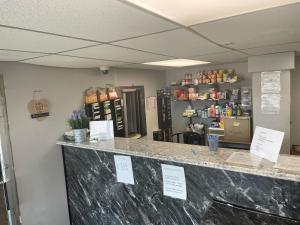 a counter in a store with signs on it at Budgetel Inn and Suites - Louisville in Louisville