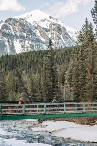 a bridge over a snow covered mountain with a view of a mountain range at Mountaineer Lodge in Lake Louise