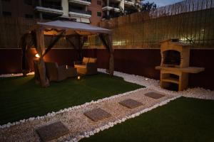 a small backyard with a gazebo and a grill at SUITE LEONARDO RELAX in Fiumicino
