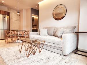 a living room with a couch and a table at Singular Dream Beach Residences in Playa del Carmen