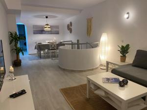 a living room with a couch and a table at Nice ground floor apartment- 2 bedrooms - 450 meters from the beach in Cabopino