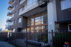 a building with a fence in front of it at Quedate aqui Centro Concepcion I in Concepción