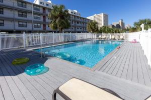 a swimming pool on a balcony of a building at Sunshine At The Beach in Orange Beach