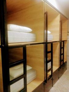 a room with three shelves with white pillows at Hippie City Hostel in Chania Town