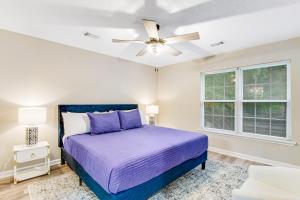 a bedroom with a bed and a ceiling fan at The Wilmington Condos Island in Savannah