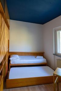 2 camas en una habitación con techo azul en Casa Olivi, en Civate