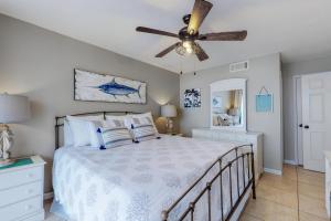 a bedroom with a bed with a ceiling fan at Seaside Beach & Racquet Club 3602 in Orange Beach