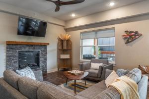a living room with a couch and a fireplace at Brand New! Lake View with Arcade Game Room! Fully stocked kitchen! in Hollister