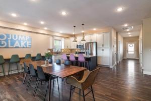 a dining room and kitchen with a table and chairs at Brand New! Lake View with Arcade Game Room! Fully stocked kitchen! in Hollister