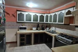 cocina con fregadero y fogones horno superior en For travelers / Entire Home in Guayaquil, en Guayaquil