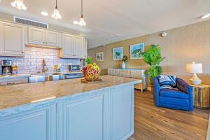 a kitchen with a counter and a living room at Maui Kai 804 Oceanfront 1 BD 1Ba condo in Kahana