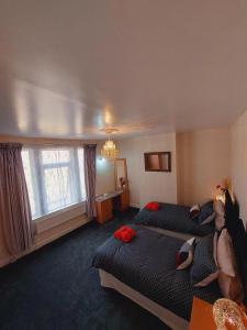 a hotel room with two beds and a chandelier at Elegant and central two bedrooms house in Bristol